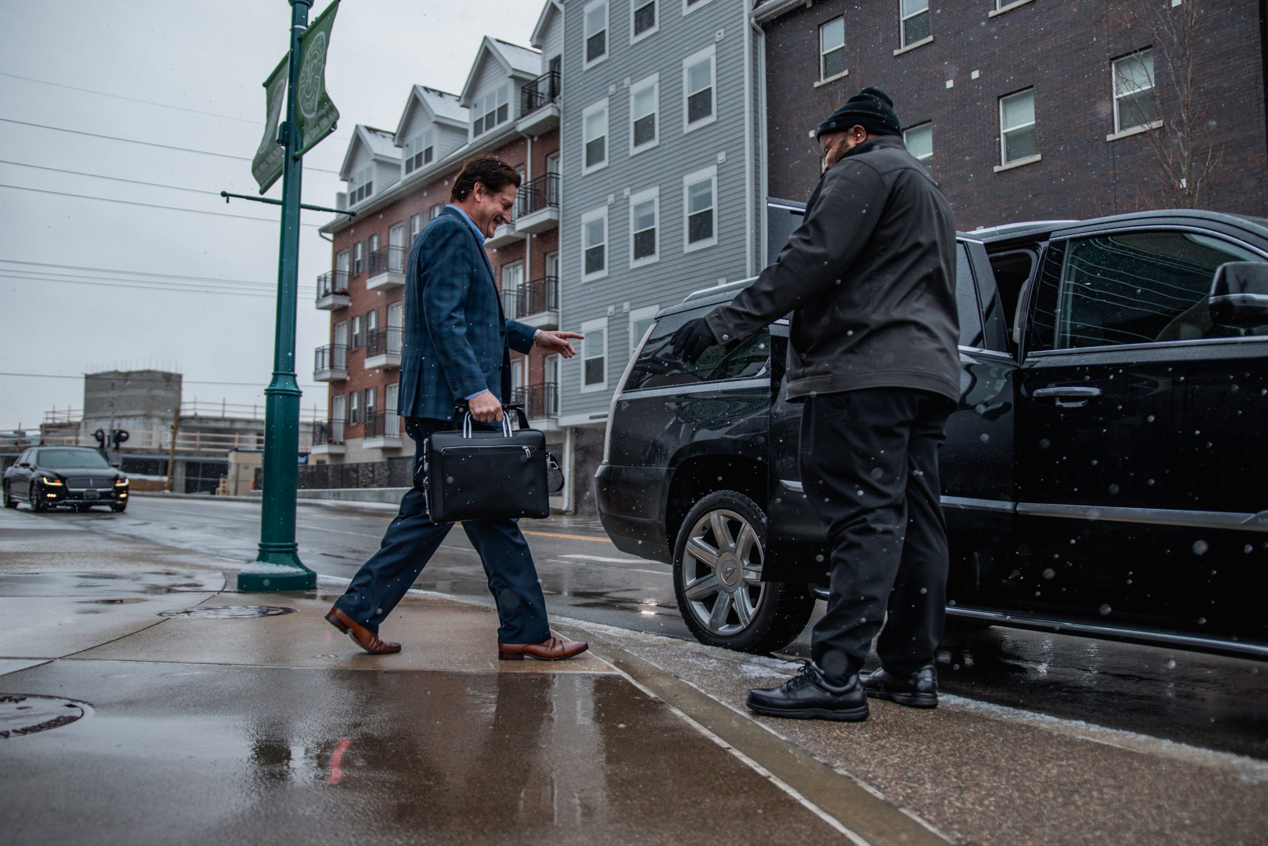 Customer Entering Cadillac Escalade from Avant Garde Limousines & Coach for Corporate